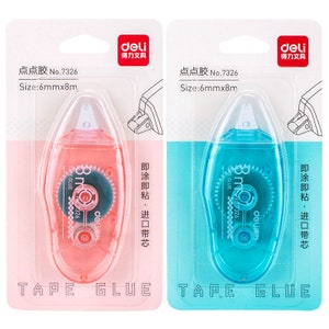 May include: Two tape glue dispensers, one pink and one blue, with a white tape roll inside. The dispensers are labeled "deli" and "点点胶 No.7326 Size:6mmx8m".