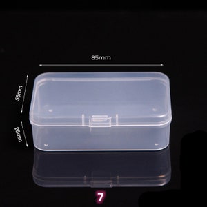 May include: Clear plastic storage box with a hinged lid. The box measures 8.5 inches long, 2.5 inches wide, and 5.5 inches tall.