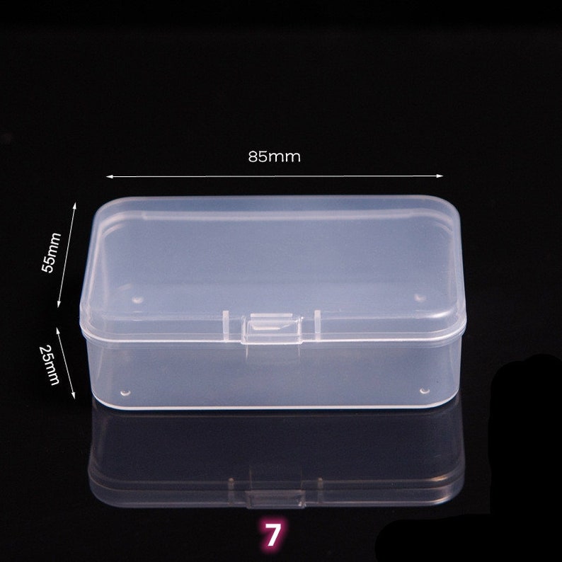 May include: Clear plastic storage box with a hinged lid. The box measures 8.5 inches long, 2.5 inches wide, and 5.5 inches tall.
