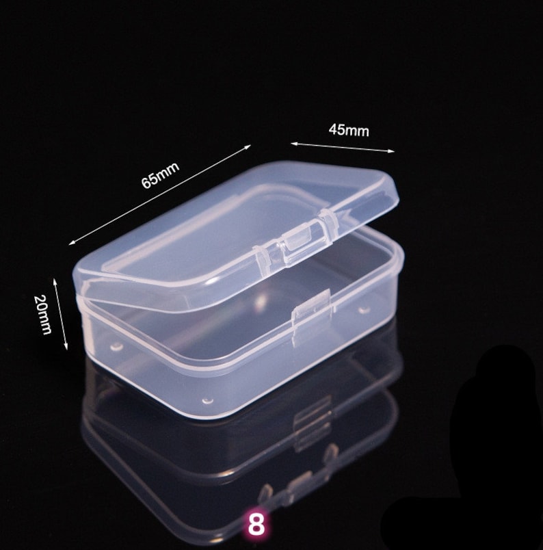 May include: A clear plastic storage box with a hinged lid. The box measures 6.5 inches long, 4.5 inches wide, and 2 inches tall.