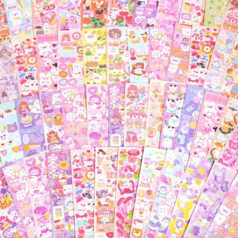May include: A set of 50 colourful, pink, and purple stickers featuring cute cartoon characters, animals, and designs. The stickers are perfect for decorating journals, planners, laptops, and other items.