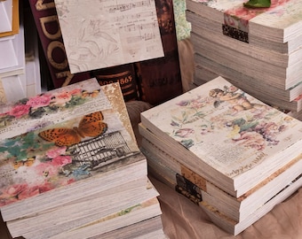 May include: A stack of vintage-style paper journals with floral and butterfly designs. The journals have a distressed, aged look and are perfect for scrapbooking, journaling, or crafting.