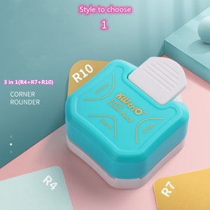 May include: A blue and white corner rounder punch with the text "KW-triO 3-WAY Corner Punch" and the measurements "R4mm" and "R7mm". The punch has three different sized rounders: R4, R7, and R10.