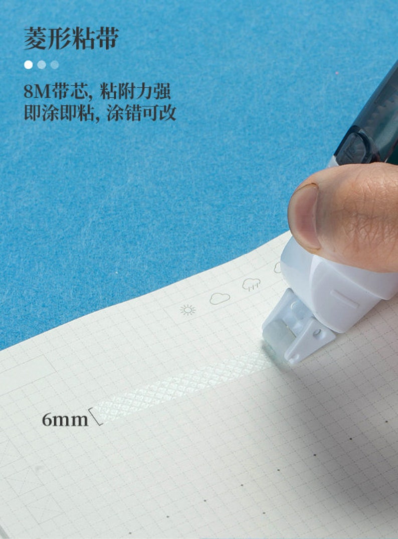 May include: A white tape dispenser with a clear tape roll. The tape is 6mm wide and has a diamond pattern. The dispenser has a black handle and a blue background.