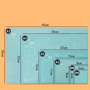 May include: A set of five cutting mats in different sizes, labeled A3, A4, A5, A6, and 6*6. The mats are light blue with a grid pattern and white lines. The largest mat is 45 cm by 30 cm, and the smallest mat is 6 cm by 6 cm.