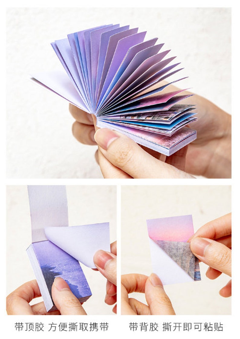 May include: A stack of colourful sticky notes with a gradient of purple, pink, and blue. The notes are folded in a fan shape and have a white backing. The notes have a variety of images printed on them, including a cityscape and a sunset.