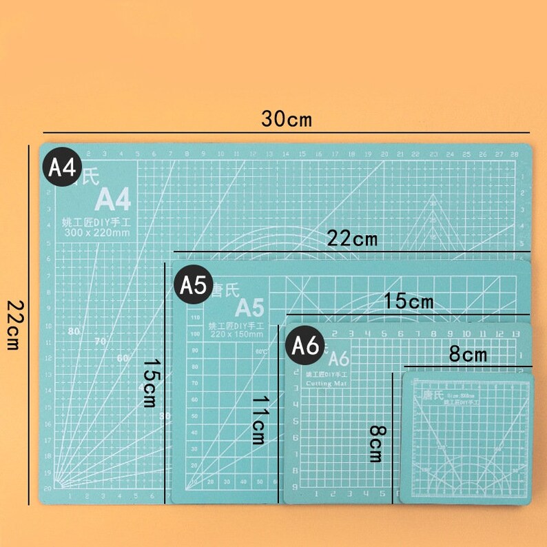 May include: Four self-healing cutting mats in different sizes. The mats are green with white grid lines. The largest mat is 30 cm by 22 cm, the next largest is 22 cm by 15 cm, the next is 11 cm by 8 cm, and the smallest is 8 cm by 8 cm. The mats are labeled A4, A5, A6, and A6. The mats are made for DIY crafts.