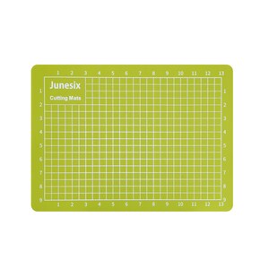 May include: A green self-healing cutting mat with a grid pattern and numbered lines. The mat is labeled "Junesix Cutting Mats".