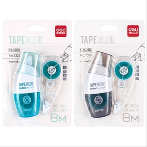 May include: Two tape glue dispensers, one blue and one grey, with a clear tape roll and a label that says "TAPE GLUE" and "No. 7325". The dispensers are packaged in white cardboard with the text "deli 得力文具" in red.