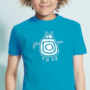 May include: A turquoise t-shirt featuring a white graphic of a stylized creature with a circular body and arms. The design is centered on the front of the shirt. The shirt has short sleeves and a crew neck.