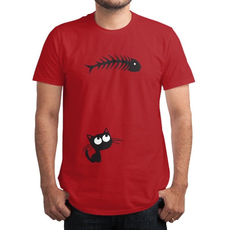 May include: A red t-shirt with a black silhouette of a fish skeleton and a black cat with big eyes looking up.
