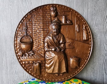 Copper wall plate, plate. Old woman by open fire