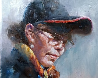 May include: A painting of a person wearing a black baseball cap with a red brim, glasses, and a colourful scarf. The person is looking down and to the right. The background is a light blue.