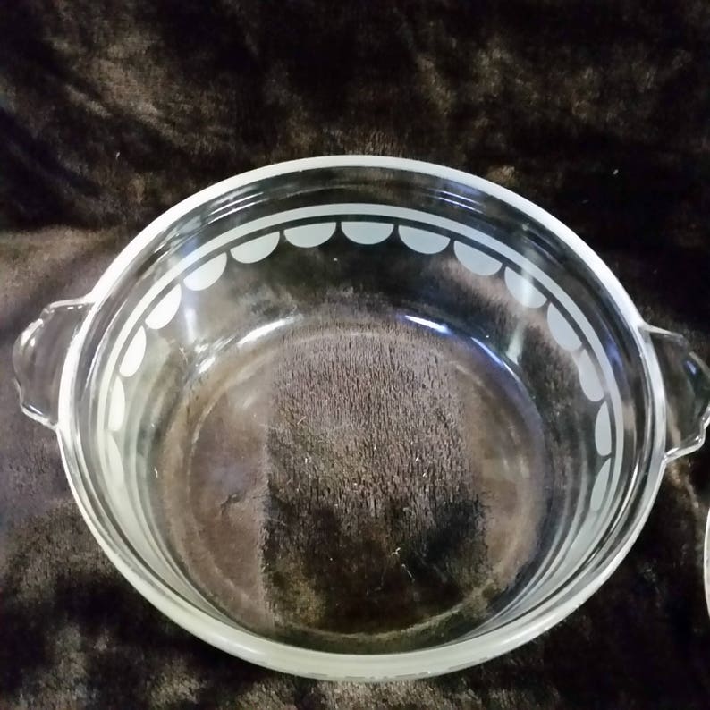 Clear with white design. Vintage pyrex casserole bowl with lid