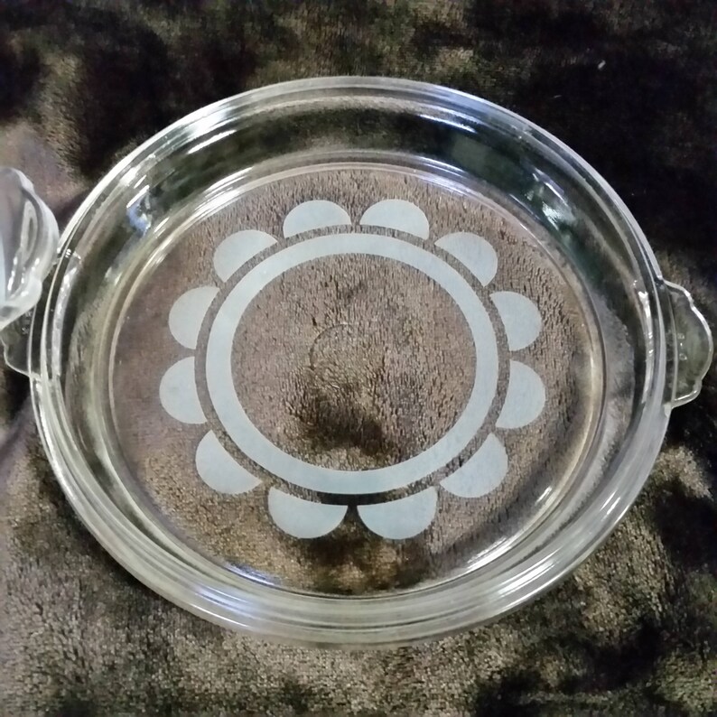 Clear with white design. Vintage pyrex casserole bowl with lid