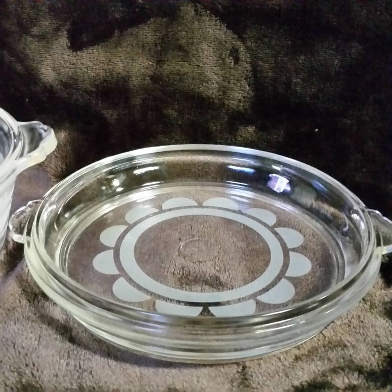 Clear with white design. Vintage pyrex casserole bowl with lid