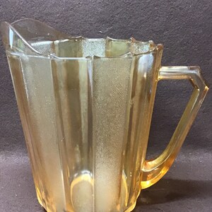 iridescent depression glass pitcher. 64 ounce capacity. Paneled design