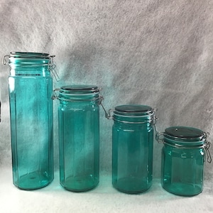 Vintage green glass canister jars. Wire closure, rubber seal. Set of 4