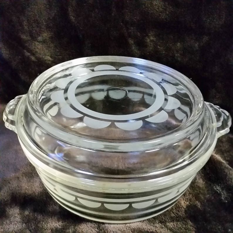 Clear with white design. Vintage pyrex casserole bowl with lid