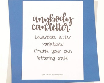 May include: A white card with the text "anybody can letter" in brown script, layered on blue and light gray cardstock. The text below reads "Lowercase letter variations: Create your own lettering style!"