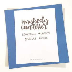 May include: A white sheet of paper with the words "anybody can letter" in brown script, along with "Lowercase alphabet practice sheets." The paper is layered on a blue and gray background.