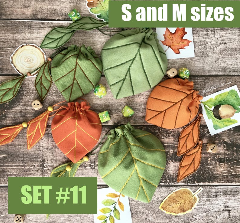 May include: A collection of leaf-shaped drawstring bags in green and orange, with matching leaf embellishments. The bags are in S and M sizes, with the text "SET #11" visible. Dice and decorative leaf accents are also present.