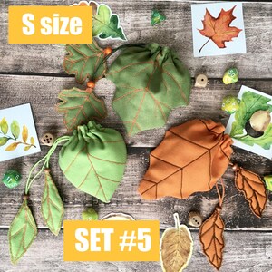 May include: A collection of leaf-shaped drawstring bags in green and orange, with brown stitching. The bags are arranged with leaf-shaped embellishments and dice. The text "S size" and "SET #5" are displayed on the image.