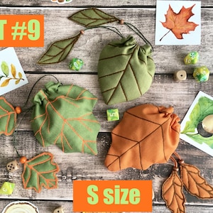 May include: Set #9 of leaf-shaped dice bags in green and orange, with matching leaf accents. The bags are labeled "S size" and are accompanied by watercolor leaf illustrations and dice.