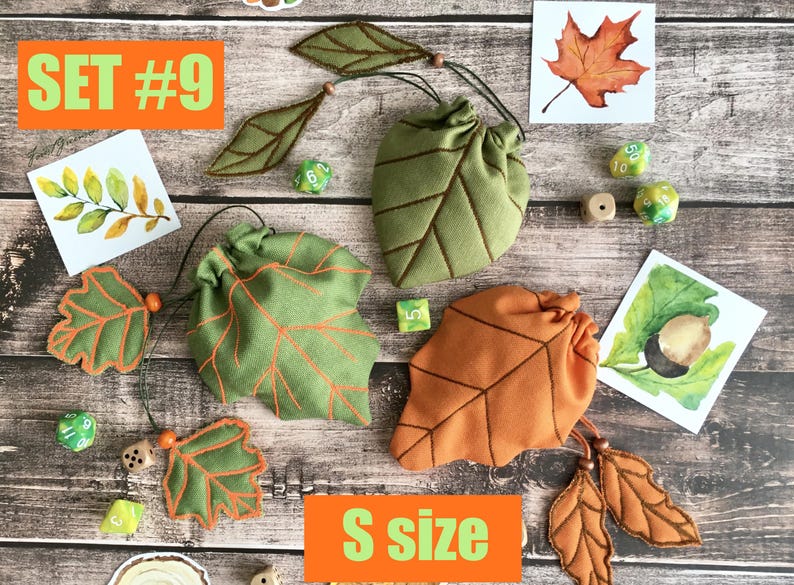 May include: Set #9 of leaf-shaped dice bags in green and orange, with matching leaf accents. The bags are labeled "S size" and are accompanied by watercolor leaf illustrations and dice.