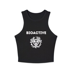 May include: Black crop top with the word "BIOACTIVE" in white block letters above a white biohazard symbol encircled by leaves. The sleeveless top is made of a soft material.