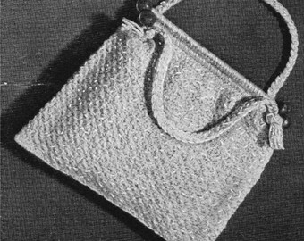 May include: A crocheted handbag with a woven handle and a tassel. The bag is made of a light-colored yarn and has a square shape.