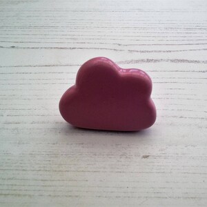 May include: A pink ceramic cloud-shaped drawer pull.