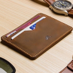 mens tan leather card holder wallet lifestyle shot, filled with cards