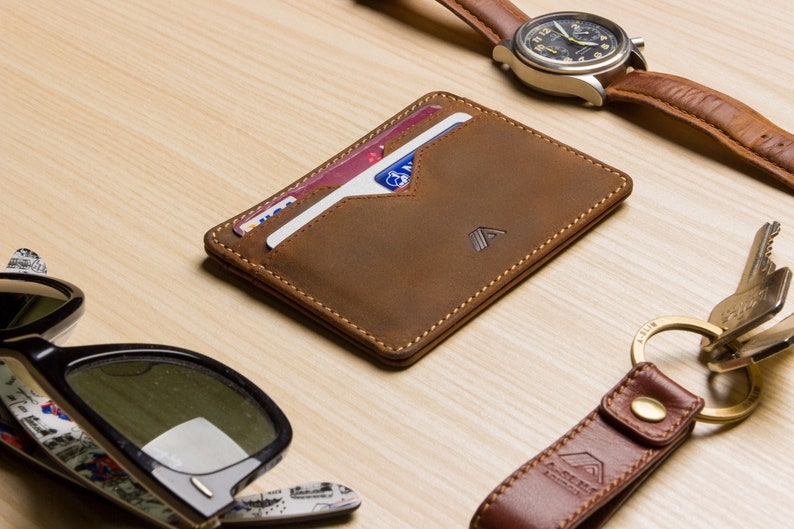 mens tan leather card holder wallet lifestyle shot, filled with cards