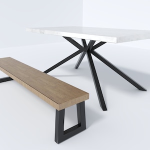 May include: A white marble top dining table with a black starburst base and a wooden bench with black metal legs.