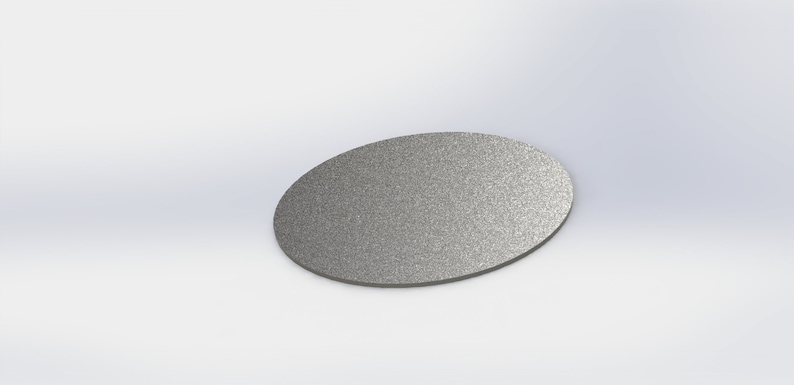May include: A silver-colored, round, metal disc with a textured surface.