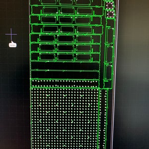 May include: A green and white circuit board with a grid pattern and multiple rows of small, round components. The board is surrounded by a black border.