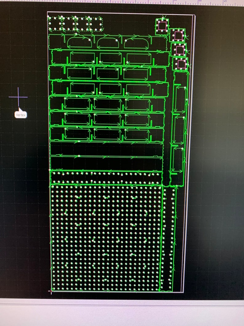 May include: A green and white circuit board with a grid pattern and multiple rows of small, round components. The board is surrounded by a black border.