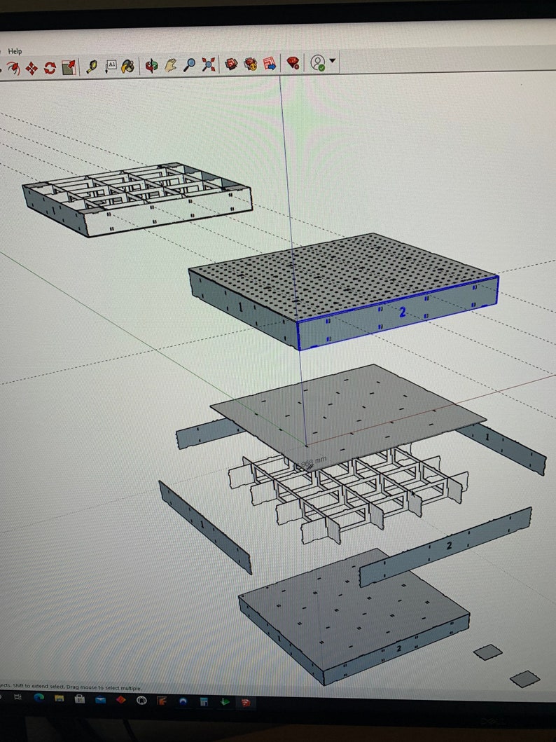 May include: A 3D model of a square metal grid with a 265 mm measurement. The grid is made up of four separate pieces, each with a number "1" or "2" printed on it. The grid is designed to be assembled into a larger structure.