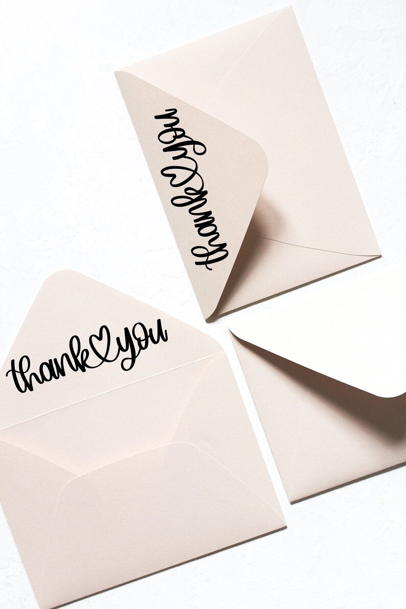 May include: Three light brown envelopes with black calligraphy. One envelope says "thank you" with a heart symbol. Another envelope says "from you".
