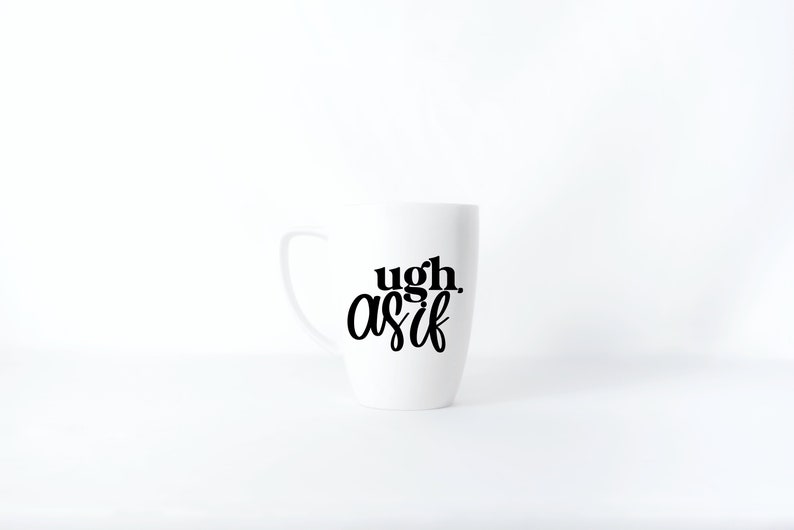 May include: White ceramic mug with black text that reads "ugh as if".