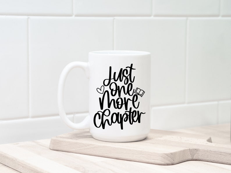 May include: White ceramic mug with a black design that says "Just one more chapter" with a small heart and open book graphic.