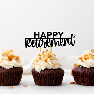 May include: Three chocolate cupcakes with white frosting and caramel drizzle topped with gold sprinkles. A black cake topper reads "HAPPY retirement".