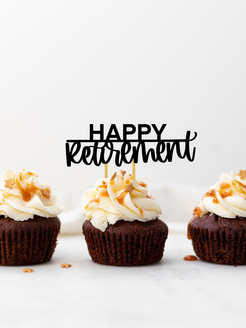 May include: Three chocolate cupcakes with white frosting and caramel drizzle topped with gold sprinkles. A black cake topper reads "HAPPY retirement".