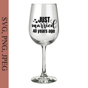 May include: A clear wine glass with a black vinyl decal that reads "JUST married 40 years ago" with two small hearts.
