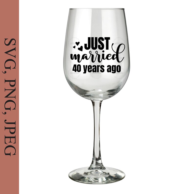 May include: A clear wine glass with a black vinyl decal that reads "JUST married 40 years ago" with two small hearts.