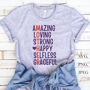 May include: Gray t-shirt with the words "AMAZING LOVING STRONG HAPPY SELFLESS GRACEFUL" arranged vertically to spell "MOTHER" in purple text with a red heart before "HAPPY".