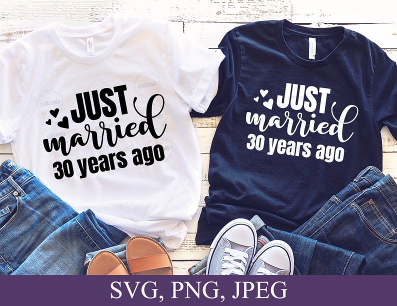 May include: Two white t-shirts with black text that reads "JUST married 30 years ago" and two small hearts. One t-shirt is white and the other is navy blue.