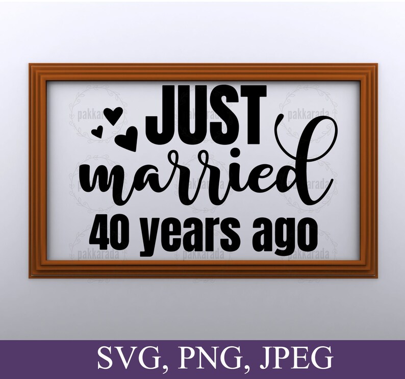May include: A brown wooden frame with a white background and black text that reads "JUST married 40 years ago" with two hearts above the word "JUST".