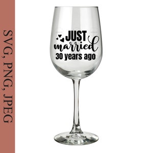 May include: A clear wine glass with a black design that says "JUST married 30 years ago" with two small hearts above the word "JUST".